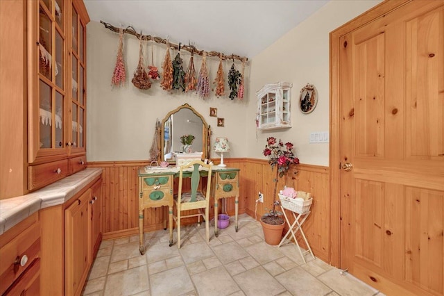 dining space with wood walls