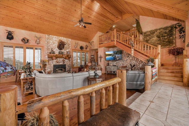 living room with beam ceiling, ceiling fan, high vaulted ceiling, light tile patterned floors, and wood ceiling