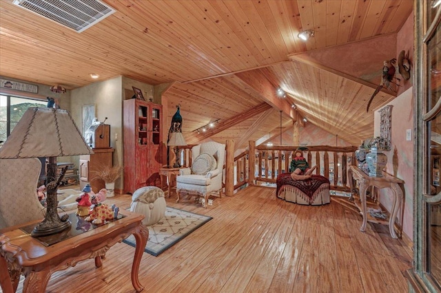 living area with lofted ceiling with beams, light hardwood / wood-style flooring, and wood ceiling