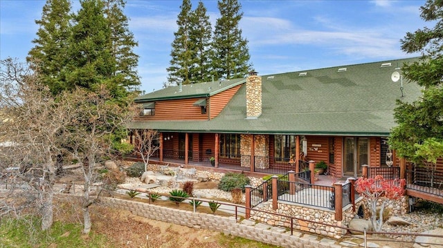 rear view of property with a porch