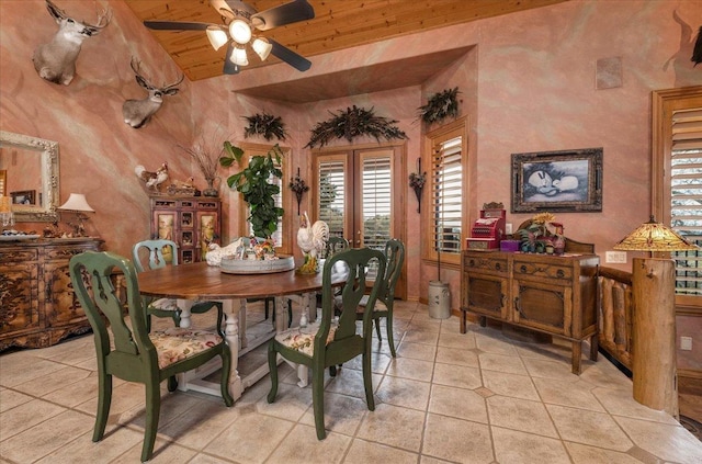 tiled dining room featuring ceiling fan, wood ceiling, and lofted ceiling