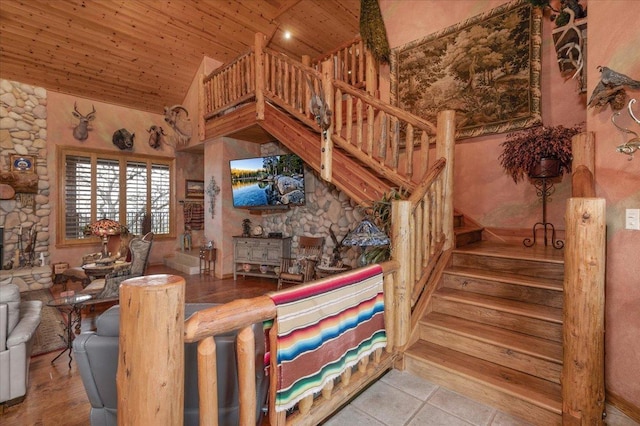 staircase featuring tile patterned floors, lofted ceiling, and wood ceiling