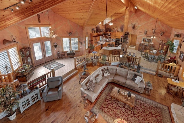 living room with wooden ceiling, high vaulted ceiling, french doors, track lighting, and light hardwood / wood-style floors