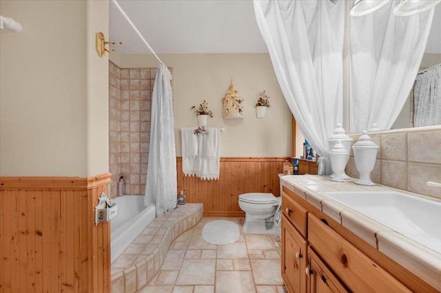 full bathroom with shower / bath combination with curtain, wood walls, toilet, and vanity