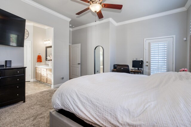 bedroom with ceiling fan, light colored carpet, ornamental molding, and ensuite bath