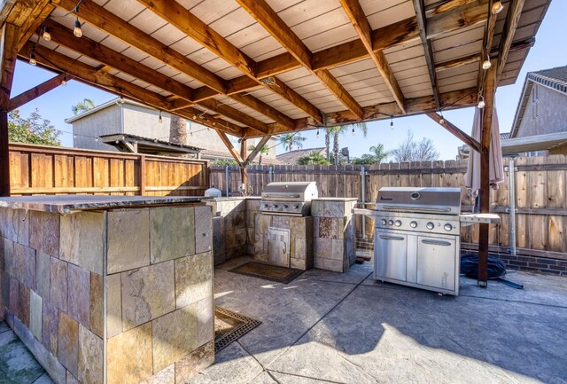 view of patio with exterior kitchen and grilling area