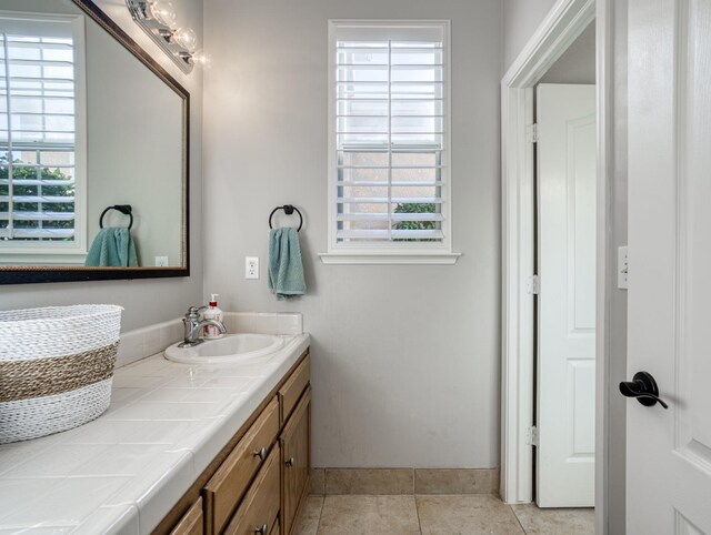 bathroom with tile patterned floors and vanity