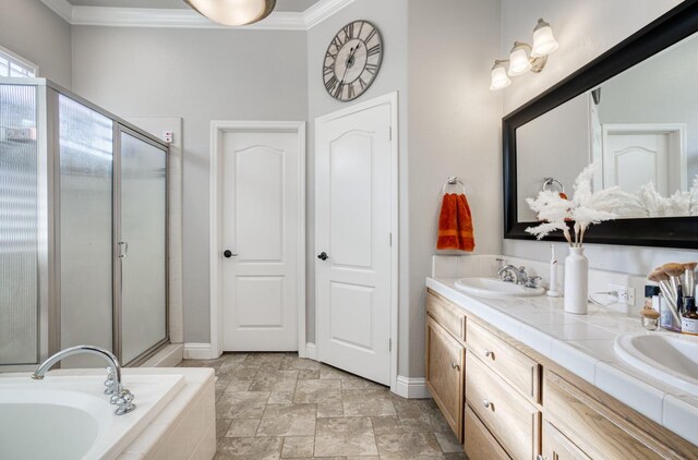 bathroom with vanity, crown molding, and shower with separate bathtub