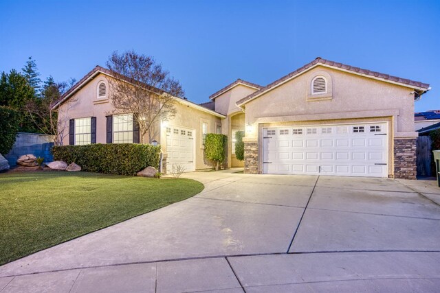 view of front of property featuring a front yard and a garage