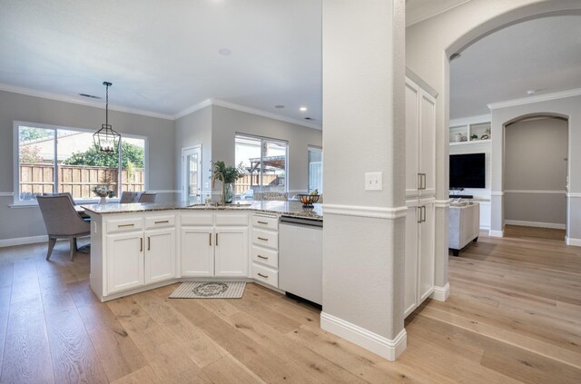 kitchen featuring light stone countertops, sink, pendant lighting, dishwashing machine, and white cabinets