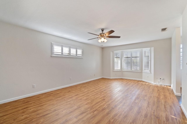 empty room with ceiling fan and light wood-type flooring