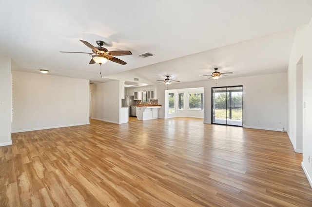 unfurnished living room featuring light hardwood / wood-style floors and lofted ceiling