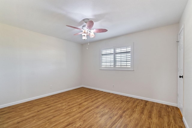 spare room with ceiling fan and light wood-type flooring