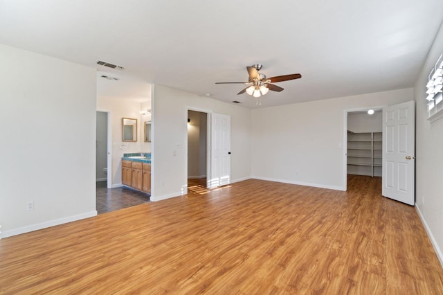 unfurnished living room with ceiling fan and light hardwood / wood-style floors