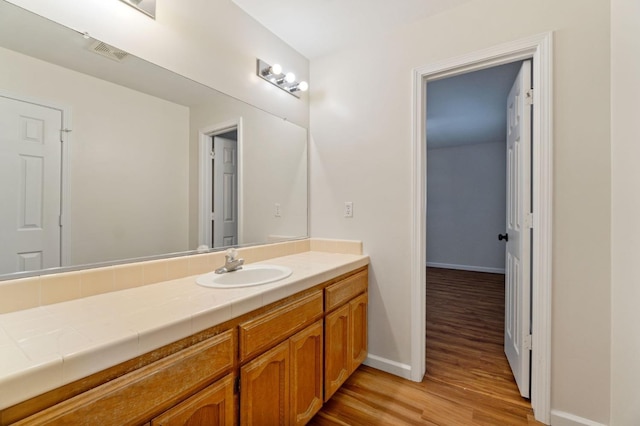 bathroom featuring hardwood / wood-style floors and vanity