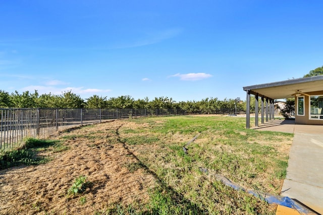 view of yard featuring a patio, a rural view, and ceiling fan