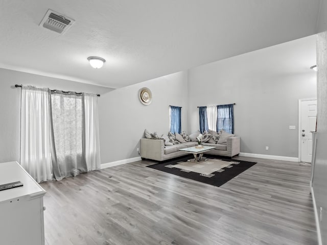 living room with hardwood / wood-style flooring and a textured ceiling