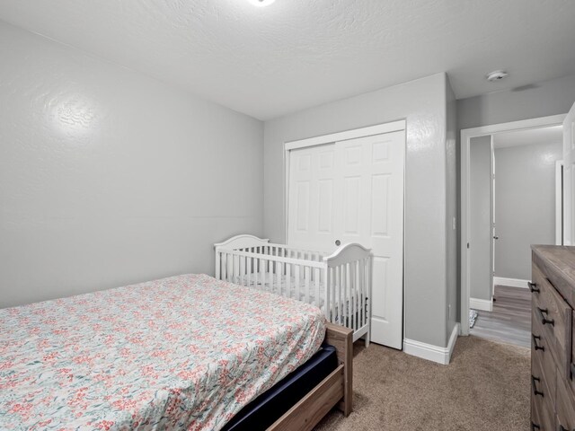 bedroom featuring light carpet and a closet