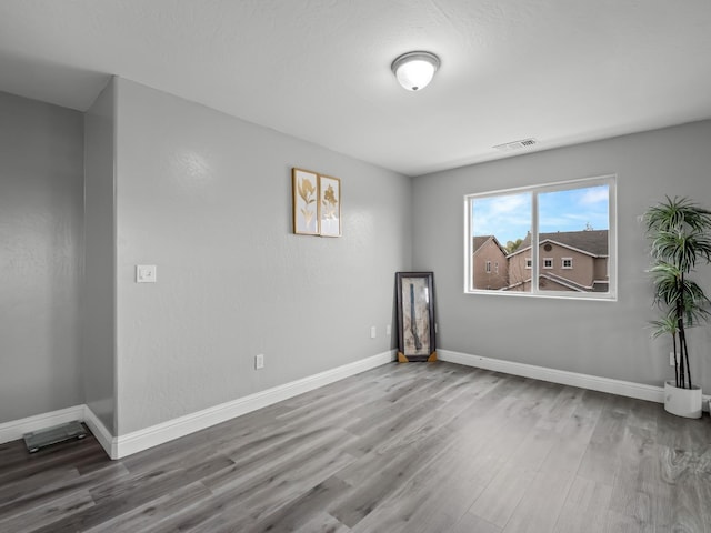 unfurnished room featuring hardwood / wood-style floors