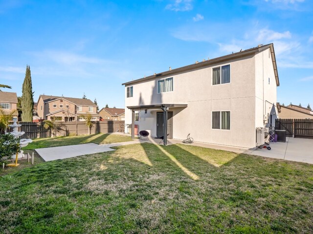 back of property featuring a yard and a patio