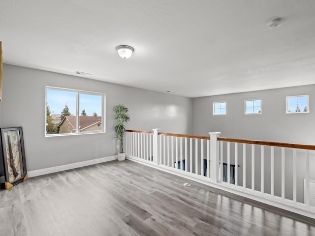 empty room with light hardwood / wood-style flooring