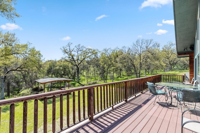 wooden deck with a lawn