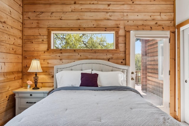 unfurnished bedroom with multiple windows and wooden walls