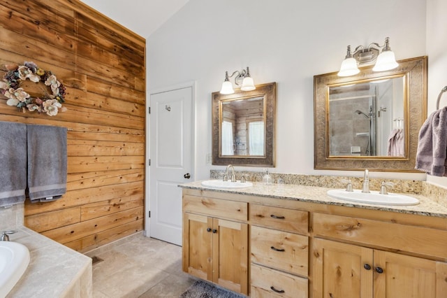 bathroom featuring tile patterned floors, vanity, independent shower and bath, and wooden walls