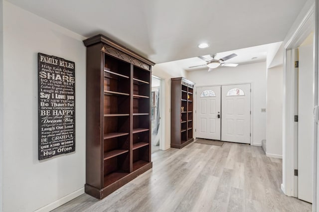 entrance foyer with ceiling fan and light hardwood / wood-style flooring