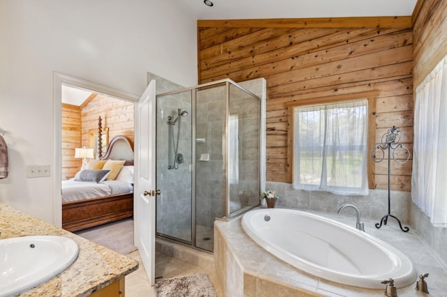 bathroom featuring tile patterned floors, vanity, independent shower and bath, and lofted ceiling