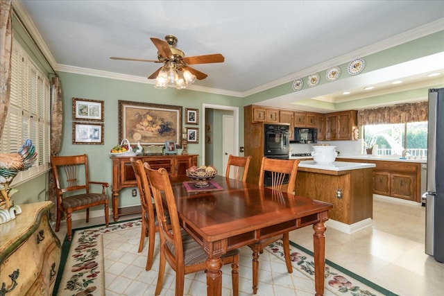 dining space featuring ceiling fan and ornamental molding