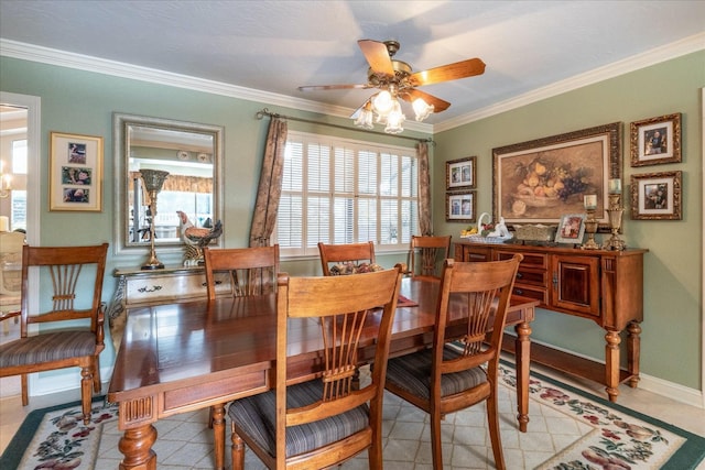 tiled dining room with ceiling fan and crown molding