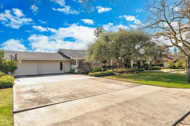 view of front of property featuring a garage and a front yard