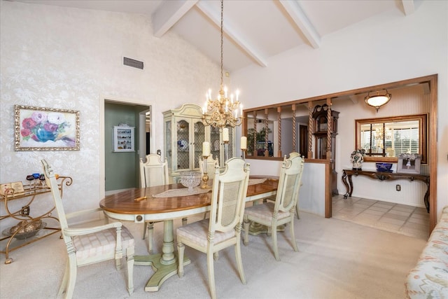 dining area with beamed ceiling, light carpet, high vaulted ceiling, and an inviting chandelier