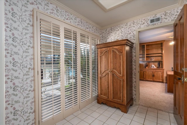 interior space with light tile patterned flooring and crown molding