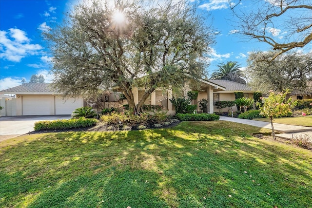 view of front of house featuring a front yard and a garage