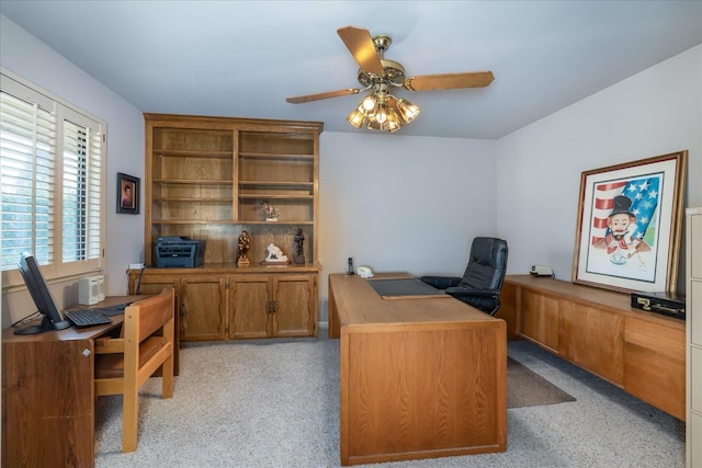 office space with ceiling fan and light carpet