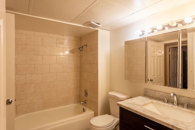 full bathroom with vanity, toilet, and tiled shower / bath