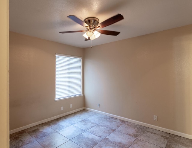 spare room featuring ceiling fan and a textured ceiling