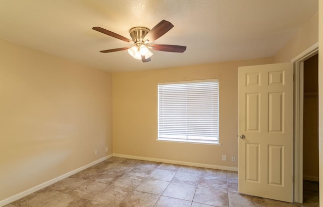 tiled empty room with ceiling fan