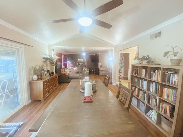 dining room with ornamental molding, light wood-type flooring, ceiling fan, and lofted ceiling