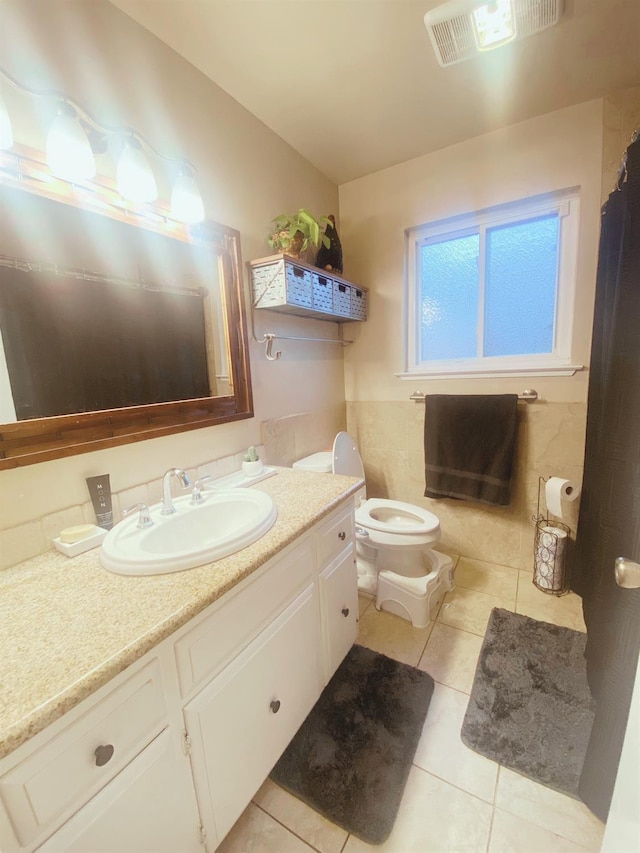 bathroom featuring tile patterned floors, vanity, and toilet