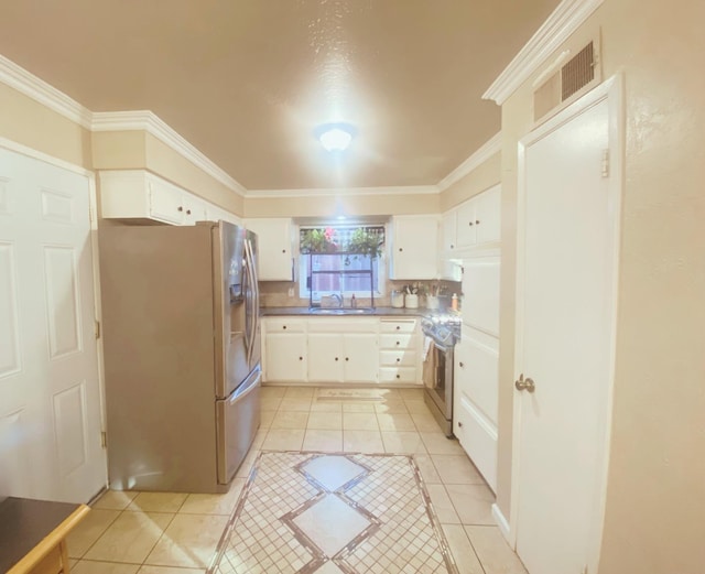 kitchen featuring white cabinets, sink, stainless steel appliances, and light tile patterned flooring