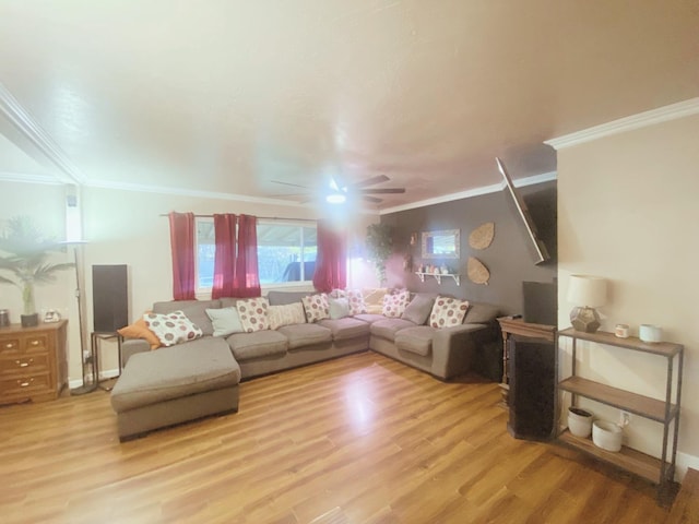 living room featuring ceiling fan, ornamental molding, and light hardwood / wood-style flooring