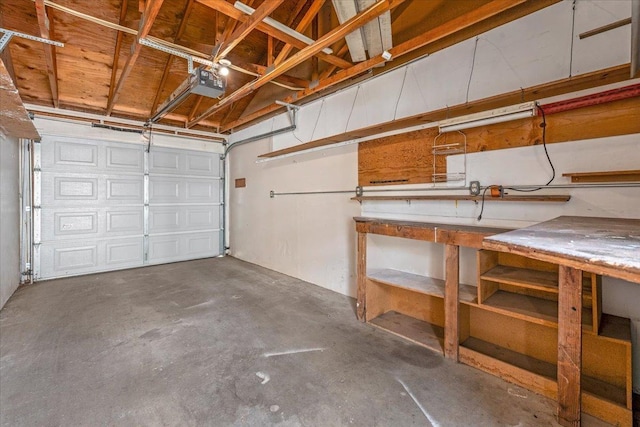 garage with a workshop area and a garage door opener