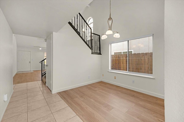 unfurnished dining area with light tile patterned floors and a chandelier