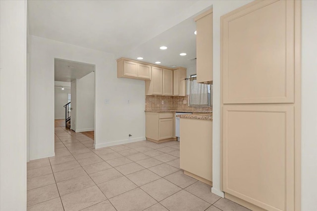 kitchen featuring dishwasher, tasteful backsplash, light tile patterned floors, and cream cabinets