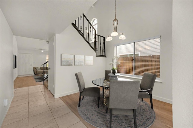 dining space featuring light tile patterned flooring and an inviting chandelier