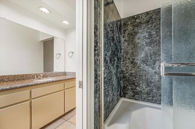 bathroom featuring tile patterned flooring, vanity, and walk in shower