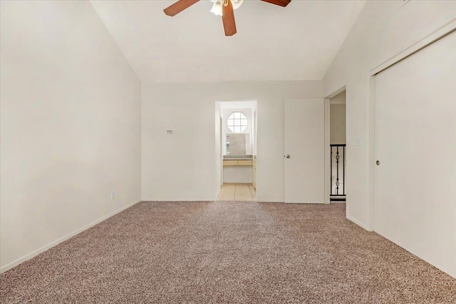 unfurnished room with ceiling fan, lofted ceiling, and light carpet